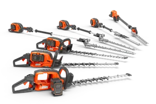 Side view of a range of hedge trimmers and pole saws displayed in a studio setting.