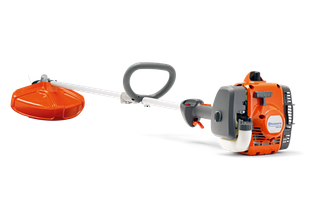 Side view of a Husqvarna brush cutter with ergonomic handle and engine.