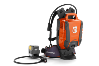 Side view of a Husqvarna battery backpack with a connected charger.