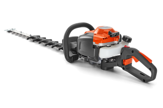 Side view of a hedge trimmer with ergonomic handle and cutting blade.