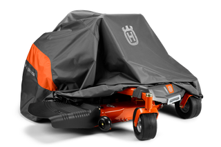 Husqvarna ride-on mower partially covered with a protective cover.