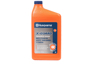 Front view of a Husqvarna X-Guard bar and chain oil bottle, highlighting its all-season formula.