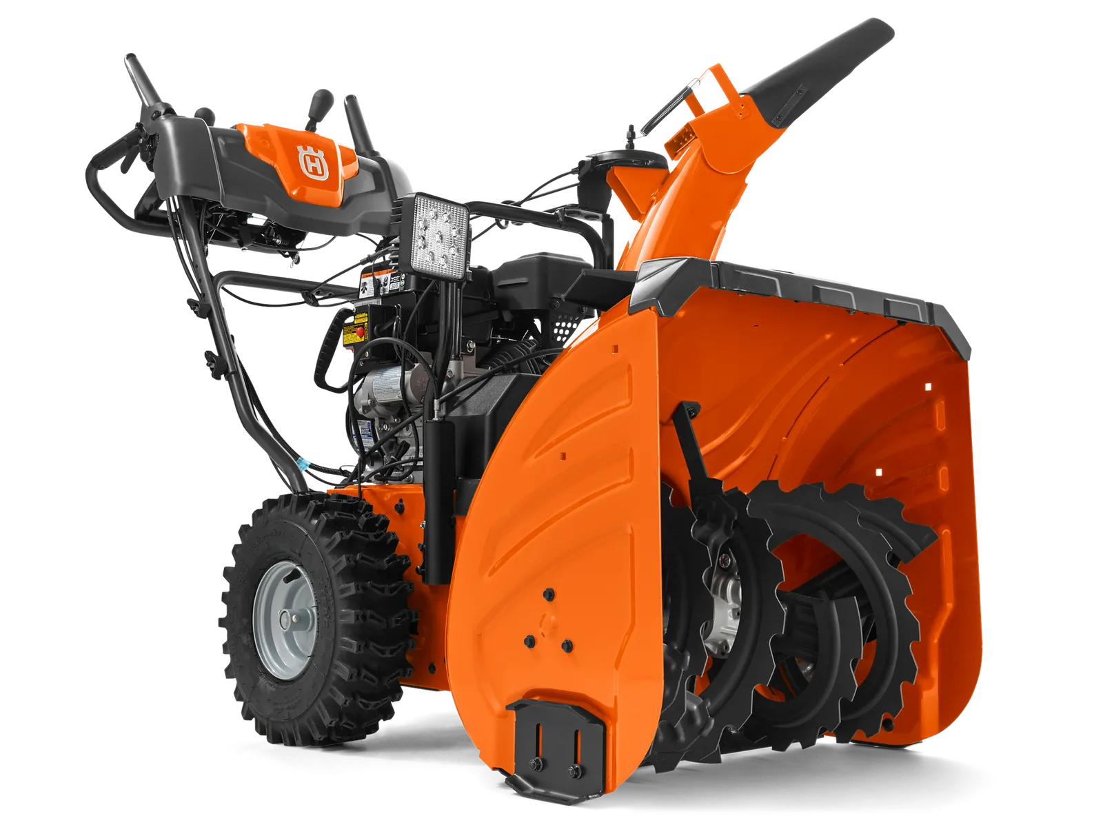 Side view of a Husqvarna snow blower with visible auger and control panel.
