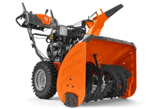 Side view of a Husqvarna snow blower showcasing its auger and controls.