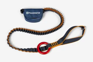 Top view of a Husqvarna tool lanyard with a red ring and adjustable strap.