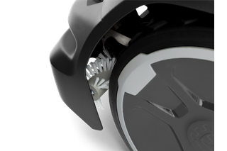 Close-up view of a robotic lawn mower wheel with integrated cleaning brush.