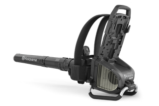 Side view of a Husqvarna leaf blower with open battery compartment.