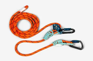 Top view of a climbing rope with carabiners and a belay device.