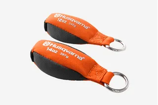 Two Husqvarna lifting weights with ring attachments, labeled 12oz and 14oz.