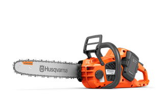 Side view of a Husqvarna chainsaw with battery compartment.
