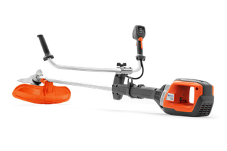 Side view of a Husqvarna brush cutter with ergonomic handle and cutting blade.