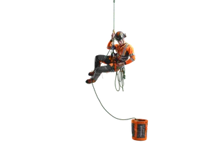 A person in work gear suspended in mid-air, holding onto a rope with a rope bag nearby.